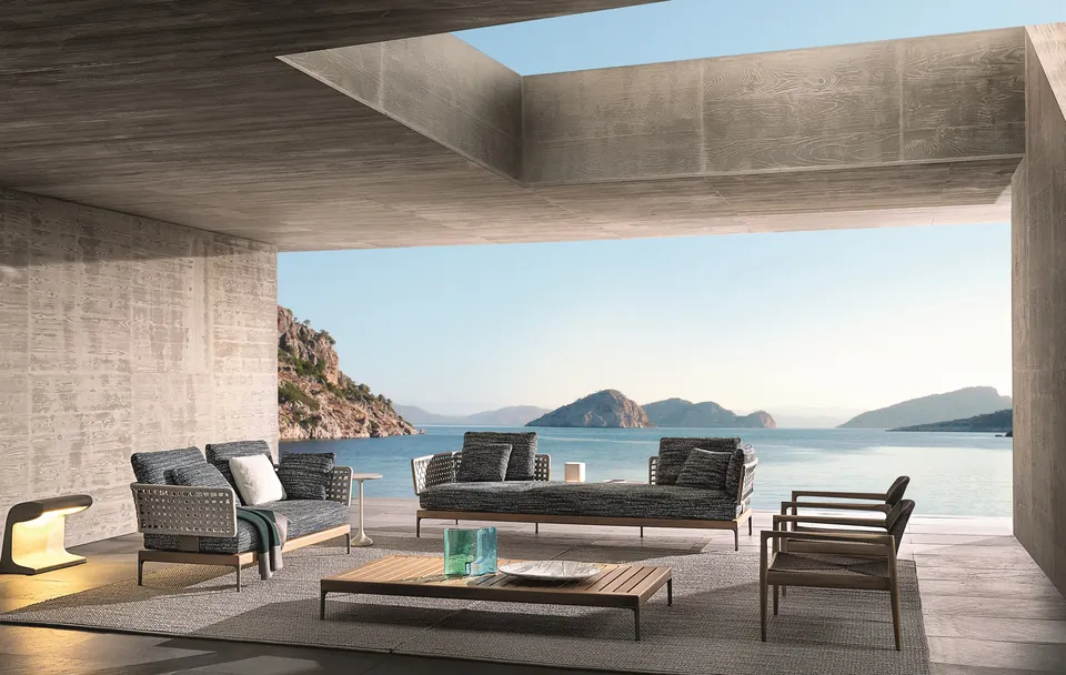 Minotti Patio Teak outdoor sofa on a teak platform by a pool, Minotti outdoor furniture