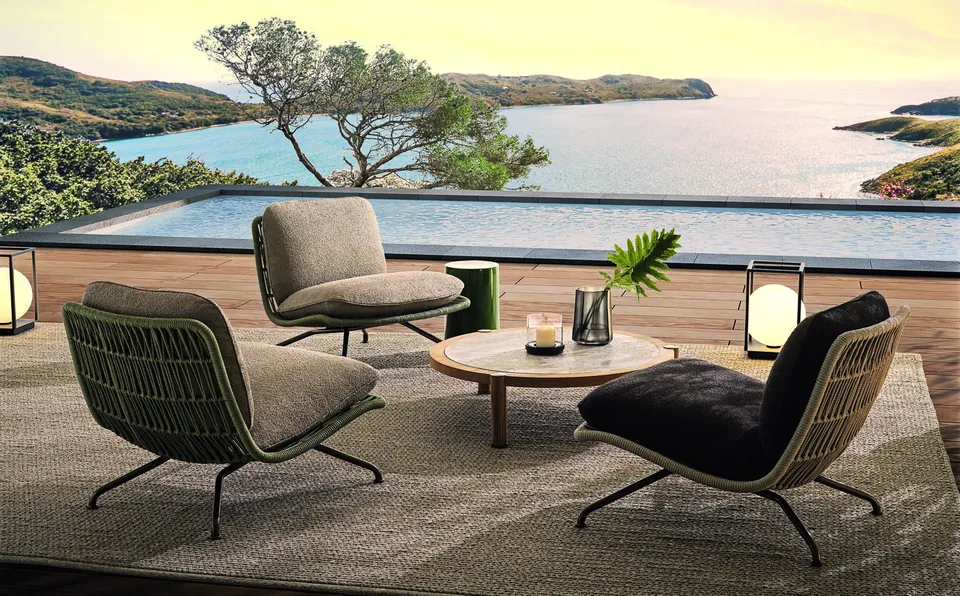Minotti Pattie Cord outdoor armchair with woven cord shell on a terrace, Minotti outdoor furniture