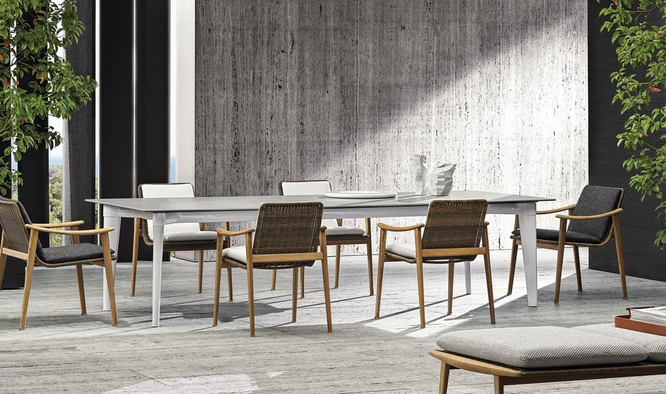 Minotti Sunray teak outdoor sofa with corded back on a garden terrace, Minotti outdoor furniture