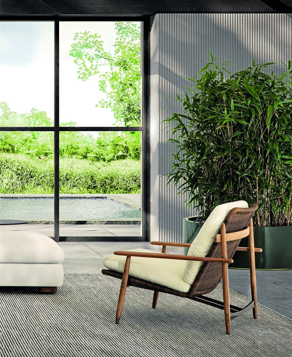 Minotti Trio teak outdoor armchair with woven cord frame by a pool, Minotti outdoor furniture